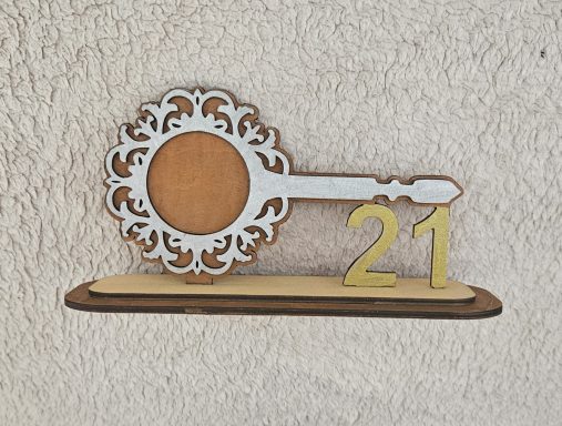 Decorative key design with the number 21 mounted on a wooden base.